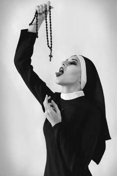 a nun holding a rosary up to her face