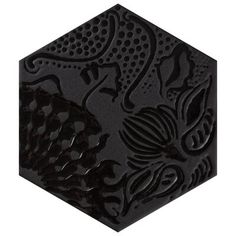 a black hexagonal tile with an intricate design