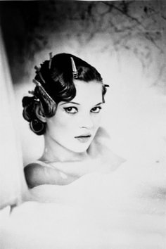 black and white photograph of a woman with her hair up in a bunt style hairstyle