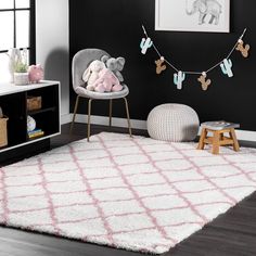 a child's room with black walls and white rugs