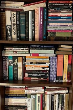 a book shelf filled with lots of books on top of wooden shelves next to each other