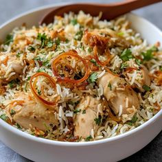 a white bowl filled with rice and chicken