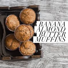 banana butter muffins in a box on top of a wooden table with a sign that reads,'banana almond butter muffins '