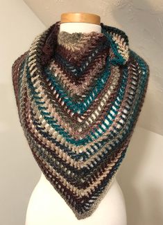 "Handmade crochet lacy shawl. Made with a multi-colored striped yarn, 70% acrylic, 30% wool yarn. This shawl is the perfect accessory for any outfit.  Colors include Teal, maroon, gray and cream  Care Instructions: Hand wash gently in cold water. Lay flat to dry. Do not bleach. Do not iron.  Scarf measurements: Longest side- 46\" Short sides- 33\" PLEASE NOTE: My shipping fees are an estimate. After package has been mailed, any shipping overages of $1.00 or more will be refunded. Ships within 7 Brown Crochet Shawl For Fall, Fall Crochet Brown Shawl, Multicolor Crochet Shawl For Fall, Brown Crochet Bohemian Shawl, Bohemian Brown Crochet Shawl, Brown Bohemian Crochet Shawl, Multicolor Yarn Shawl For Fall, Crochet Yarn Shawl For Fall, Fall Yarn Shawl Scarf