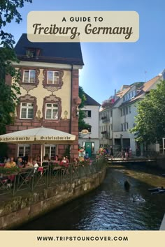 people sitting at tables on the side of a river in germany with text overlay reading a guide to freiburg, germany