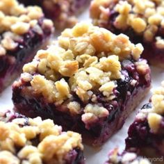 blueberry crumble bars are sitting on a white surface