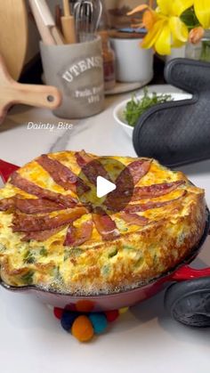 a pizza sitting on top of a pan covered in cheese and bacon next to other food items