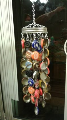 a bottle cap wind chime hanging from a door