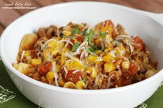 a white bowl filled with chili and corn