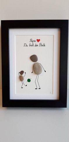 two rocks in a black frame with the words love and one is holding a green ball