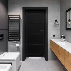 a modern bathroom with grey walls and white fixtures