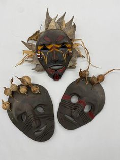 three african masks with different designs on them