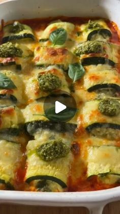 a casserole dish filled with zucchini and spinach covered in cheese