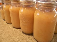 several jars filled with liquid sitting on top of a counter