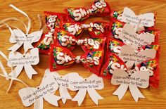 some candy bags with tags on them sitting on a table