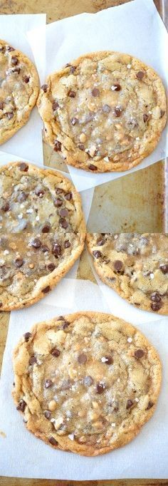 six chocolate chip cookies sitting on top of parchment paper