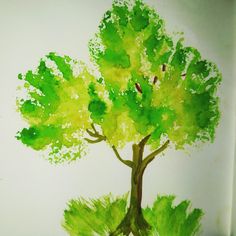 a drawing of a tree with green leaves on it's trunk and bottom half