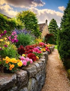 A stone wall in a cottage garden with vibrant flowers, including yellow marigolds, red geraniums, and pink begonias, set against a charming house backdrop. Cottage Garden Borders, Line Stone, Rustic Stone, Stone Walls, Stone Wall