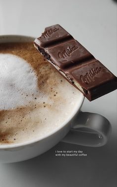 a close up of a cup of coffee with chocolate