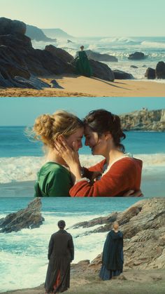 two women are standing on the beach and one is holding her face to her chest