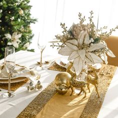 the table is set with gold and white decorations