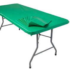 a green plastic table with folded napkins on it's top and two legs