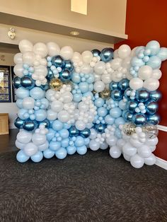 the balloon wall is decorated with blue and white balloons