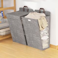 two storage bins with clothes in them on the floor