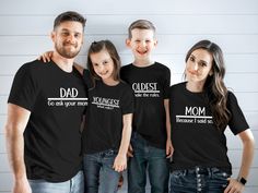 a man and two girls are wearing matching t - shirts