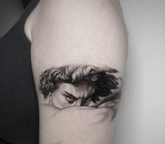 a woman's arm with a black and white drawing of a face on it