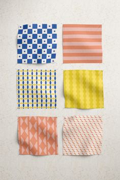 four different colored pieces of cloth on a white surface