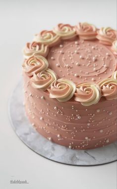 a close up of a cake on a plate with icing and sprinkles