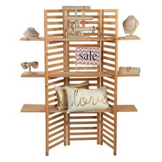 a wooden shelving unit with pillows and other items on the shelves, including a love pillow