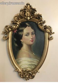 a painting of a woman in a gold frame