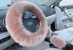 the interior of a car with a steering wheel cover and fuzzy fur trimmings