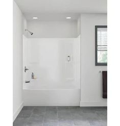 an empty bathroom with tile flooring and white walls