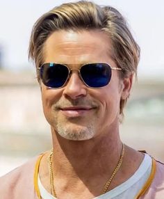 a man wearing sunglasses and smiling at the camera