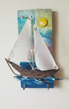 a small sailboat on a blue and white background with an egg in the back