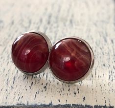 These cabs are amazingly cool.  They are a dark red blood color with a pearly marble finish. Looks exactly like blood.  These high quality resin cabs are set in pure 12mm stainless steel trays and push back with butterfly clasps. Easy to put on and take off. Lightweight. Tarnish-Free and Hypoallergenic. Perfect for every day gothic look🩸 **IS THIS A GIFT?  If your jewelry piece is a gift, make sure to mark it as such and include a gift msg (if wanted) so I see it! Jewelry Vampire, Vampire Jewelry, Blood Drop, Earrings Gothic, Gothic Looks, Marble Finish, Red Blood, Blood Red, Gothic Jewelry