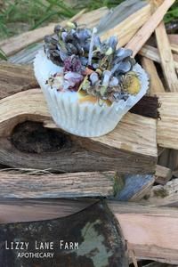 a cupcake sitting on top of a pile of wood