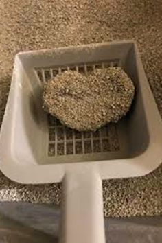 a heart shaped rock sitting on top of a metal grate