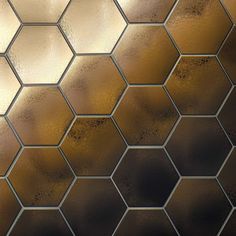 a close up view of a metallic hexagonal tile pattern with gold and brown highlights