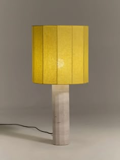 a yellow lamp sitting on top of a white table