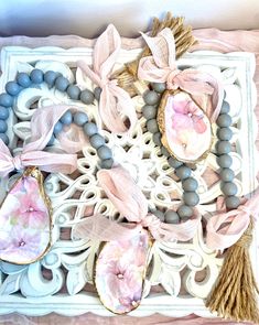 an ornate tray with beads, tassels and other items on it's surface