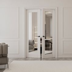 an empty living room with white walls and furniture in the corner, as well as a mirror on the wall