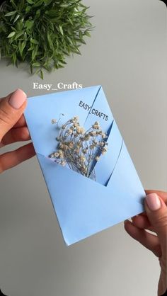 someone is holding an easy crafts book with dried flowers in the front and bottom corner