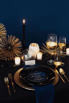 a black table topped with candles and plates