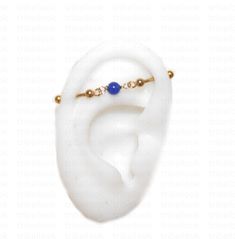 a white ear with a blue bead on it