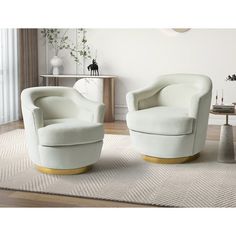 two white chairs sitting on top of a rug