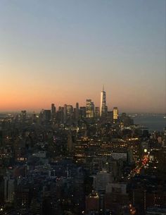 an aerial view of the city skyline at sunset or dawn with skyscrapers in the distance